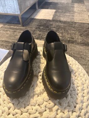 Dr. Martens Black Leather T‑Bar Loafers with Yellow Stitching. WWOB